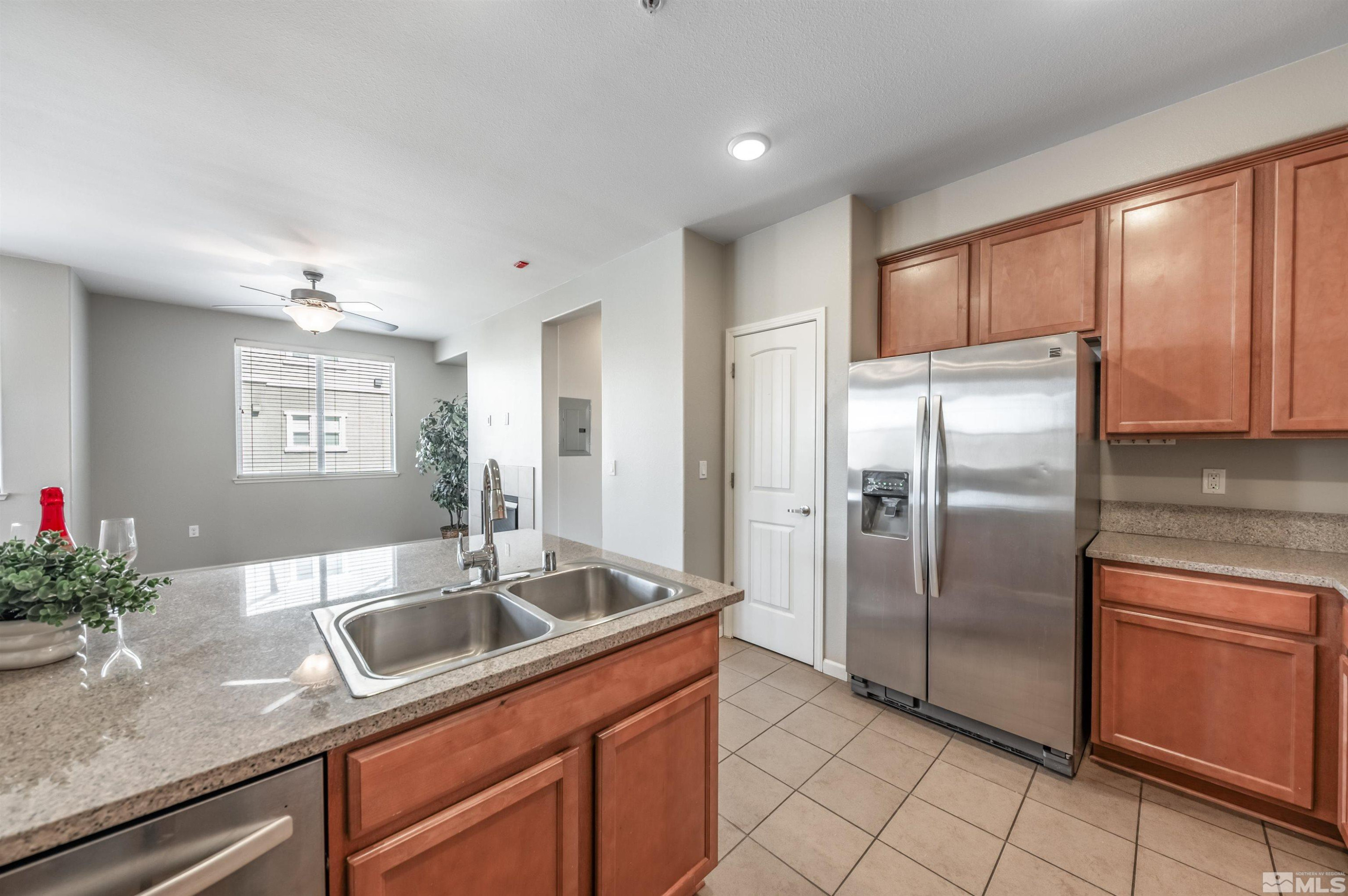 2490 Eastshore Place, Unit 602 Reno, NV 89509 - Photo 18 of 36 a kitchen with stainless steel appliances granite countertop a refrigerator a sink a stove with cabinets