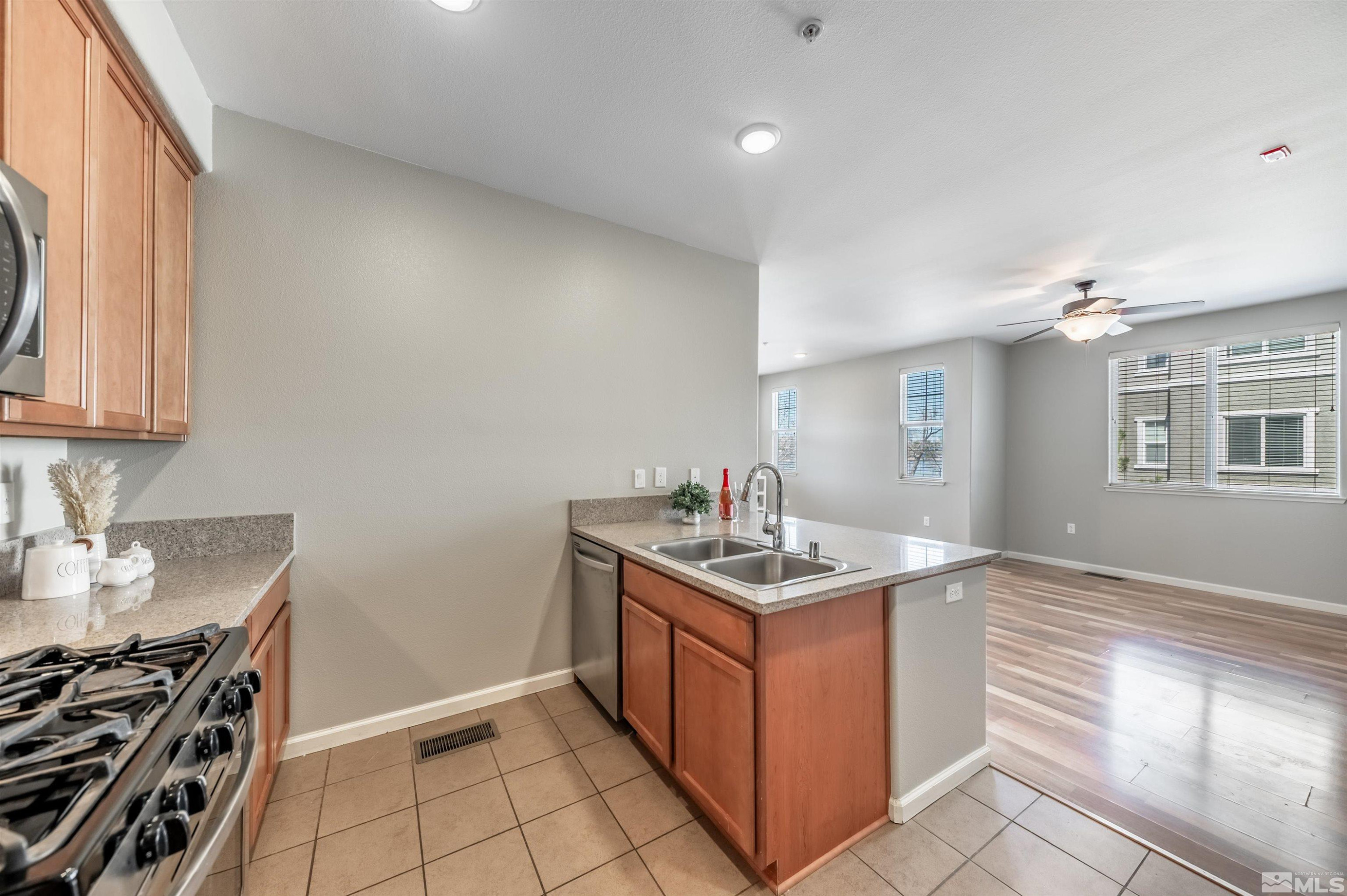 2490 Eastshore Place, Unit 602 Reno, NV 89509 - Photo 19 of 36 a kitchen with stainless steel appliances granite countertop a sink stove and cabinets