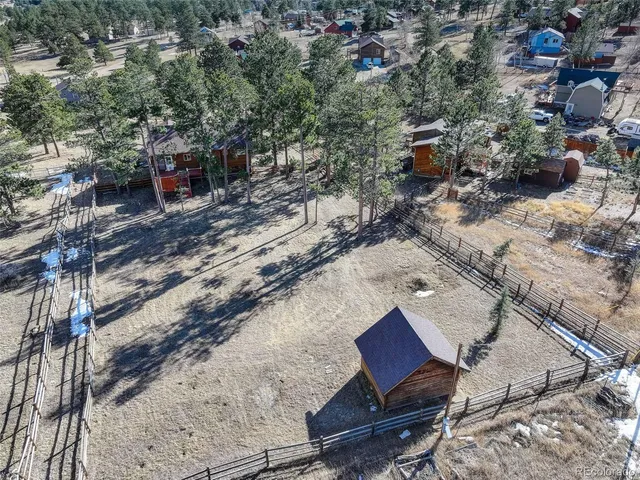 an aerial view of a house with a yard and lake view