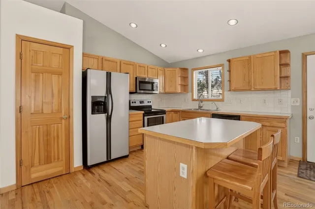 a kitchen with a refrigerator a sink and a cabinets