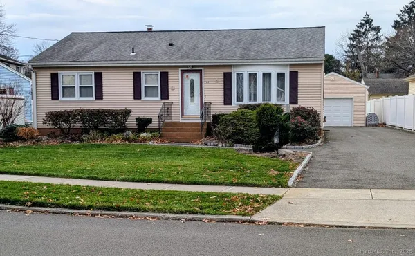 a front view of a house with a garden