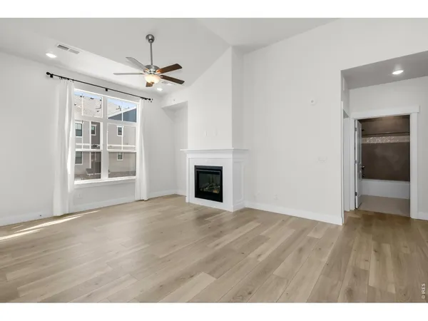 a view of an empty room and wooden floor