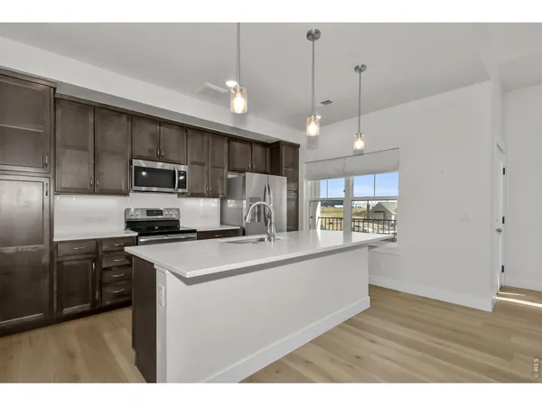 a bathroom with a sink a toilet a mirror and shower