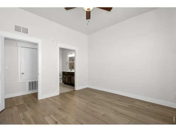 a view of a white house with a swimming pool in front of it