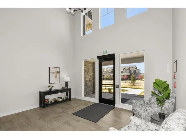 a view of an empty room with closet and wooden floor