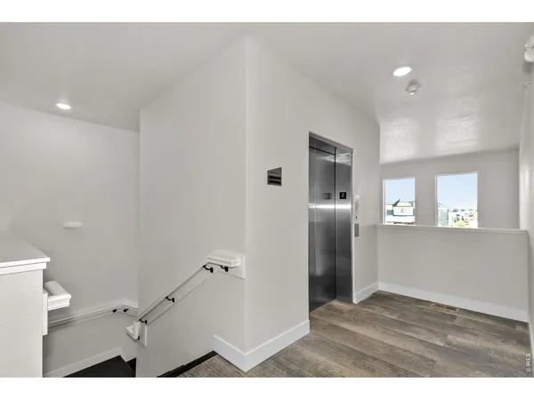 a living room with furniture kitchen view and a chandelier