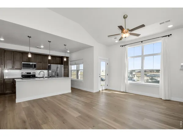 a kitchen with kitchen island a sink stainless steel appliances and cabinets