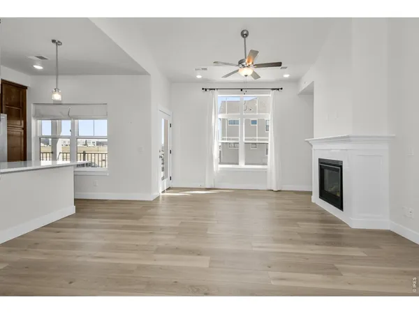 a kitchen with a sink a counter space and wooden floor
