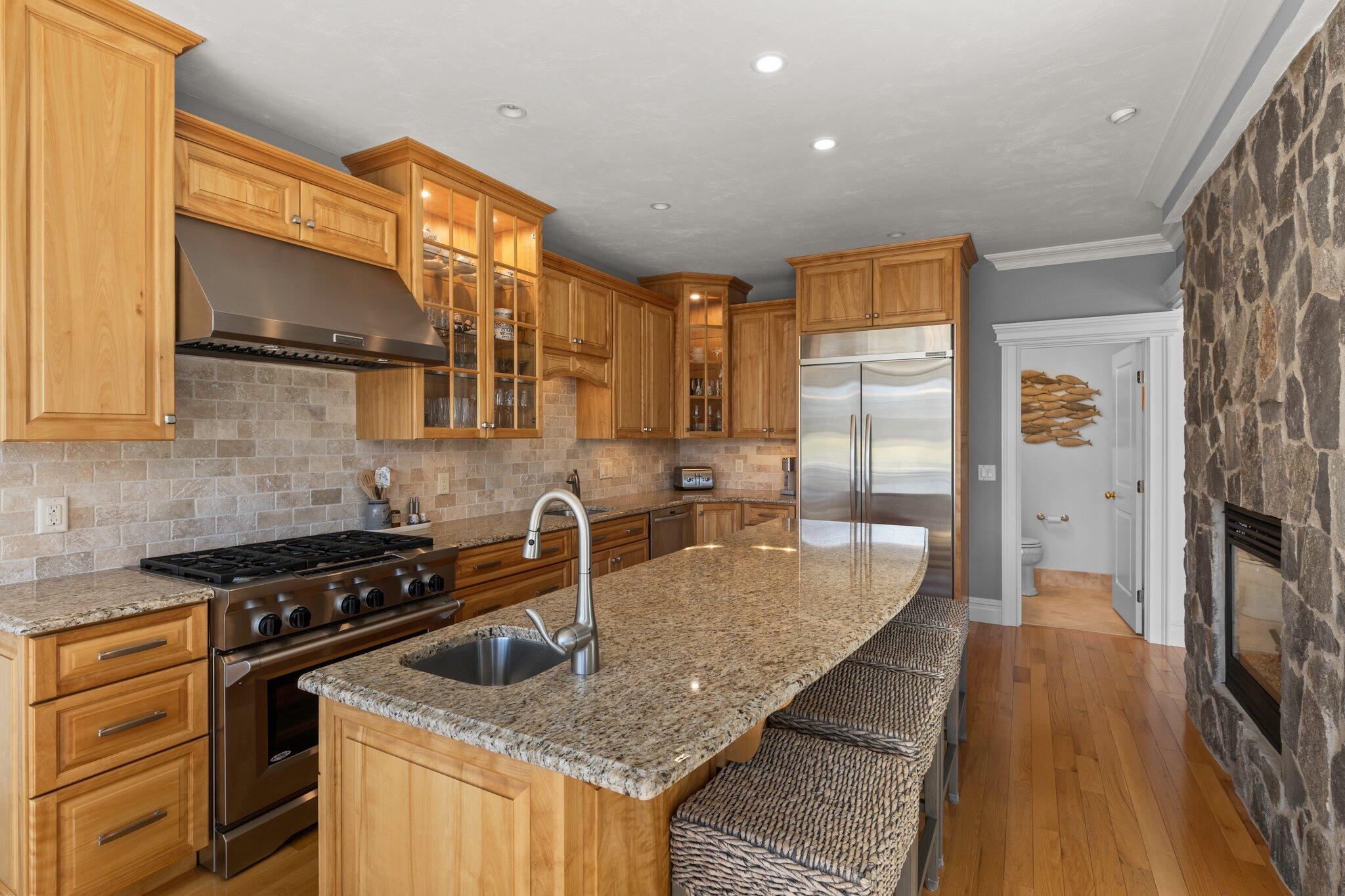 16 Quinns Way Mashpee, MA 02649 - Photo 11 of 59 a kitchen with stainless steel appliances granite countertop a sink a stove and a wooden floors