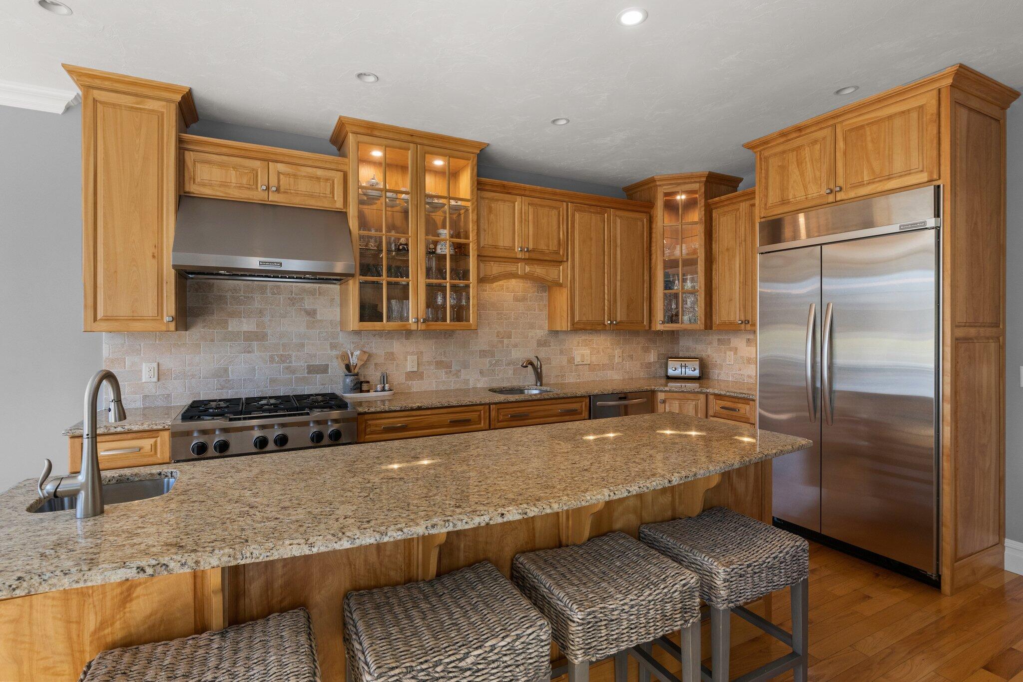 16 Quinns Way Mashpee, MA 02649 - Photo 12 of 59 a kitchen with stainless steel appliances granite countertop a refrigerator a stove and a sink with wooden floor