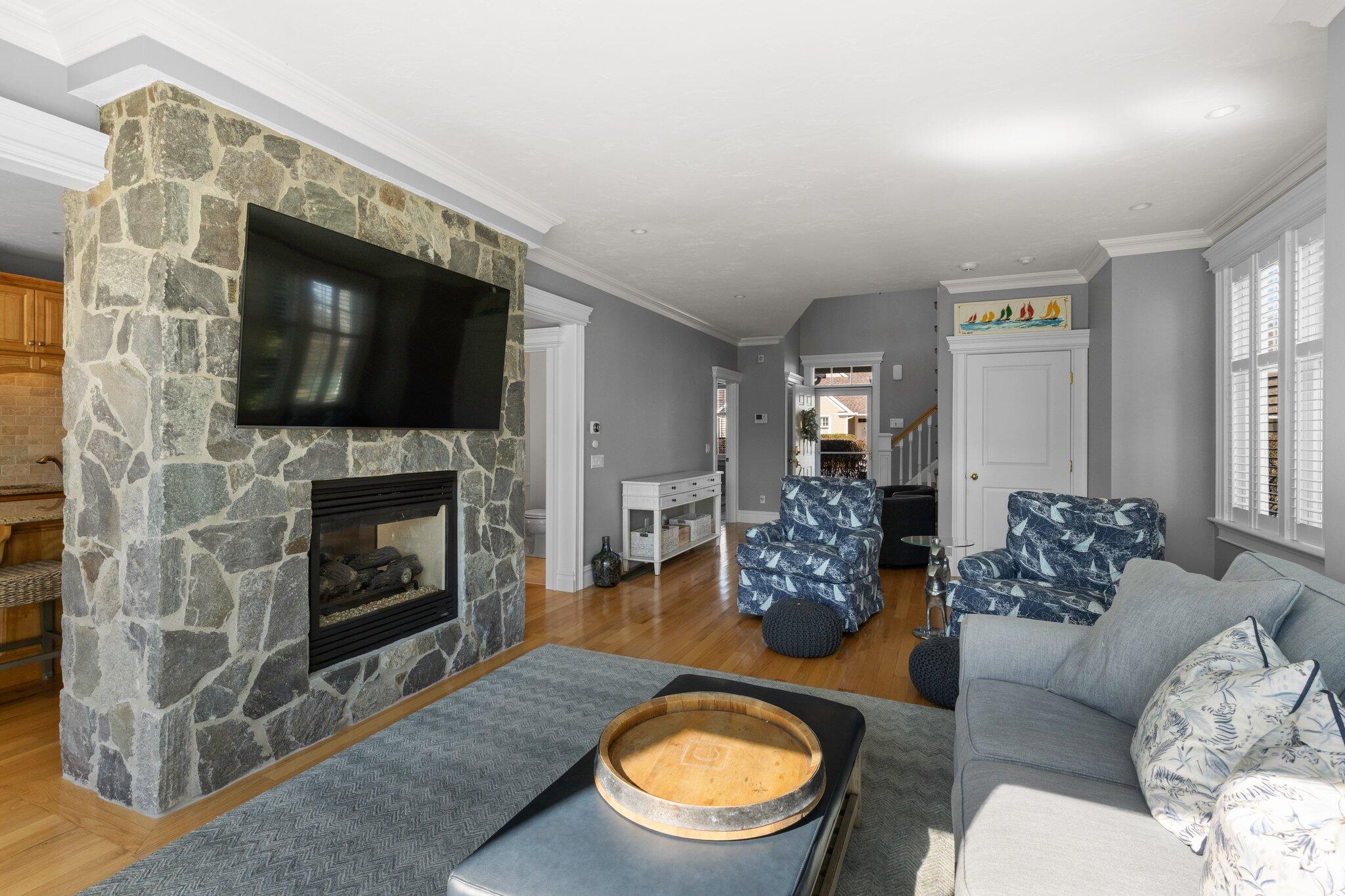 16 Quinns Way Mashpee, MA 02649 - Photo 7 of 59 a living room with furniture a flat screen tv and a fireplace