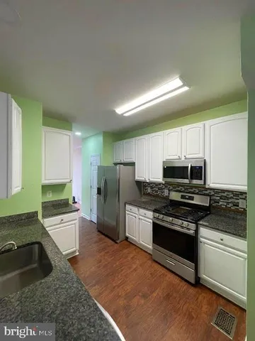a kitchen with a sink stove and refrigerator