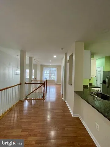 a view of a living room and kitchen with a large window
