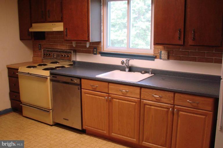 2326 Archdale Road Reston, VA 20191 - Photo 7 of 8 a kitchen with stainless steel appliances granite countertop cabinets sink and window