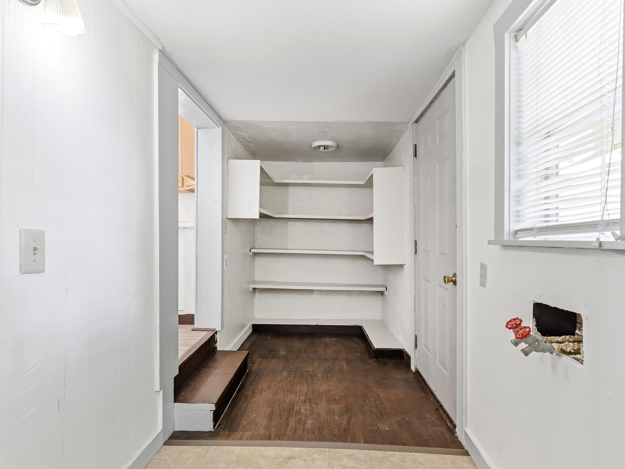 737 9th Street Port Arthur, TX 77640 - Photo 18 of 20 a view of a hallway with wooden floor and windows