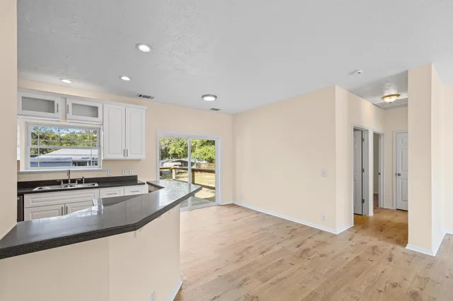 a large kitchen with stainless steel appliances granite countertop a refrigerator and a sink