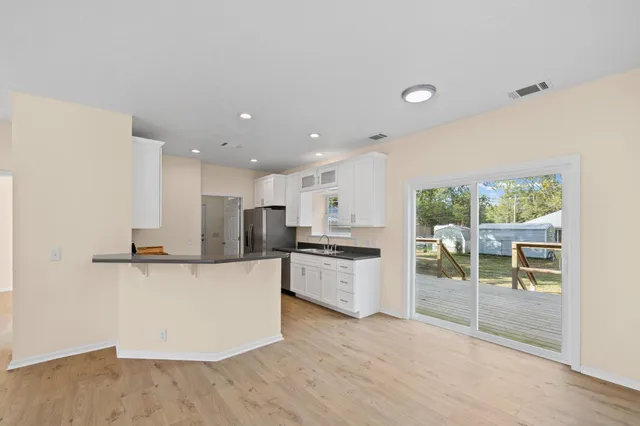 a large kitchen with a lot of counter space and stainless steel appliances