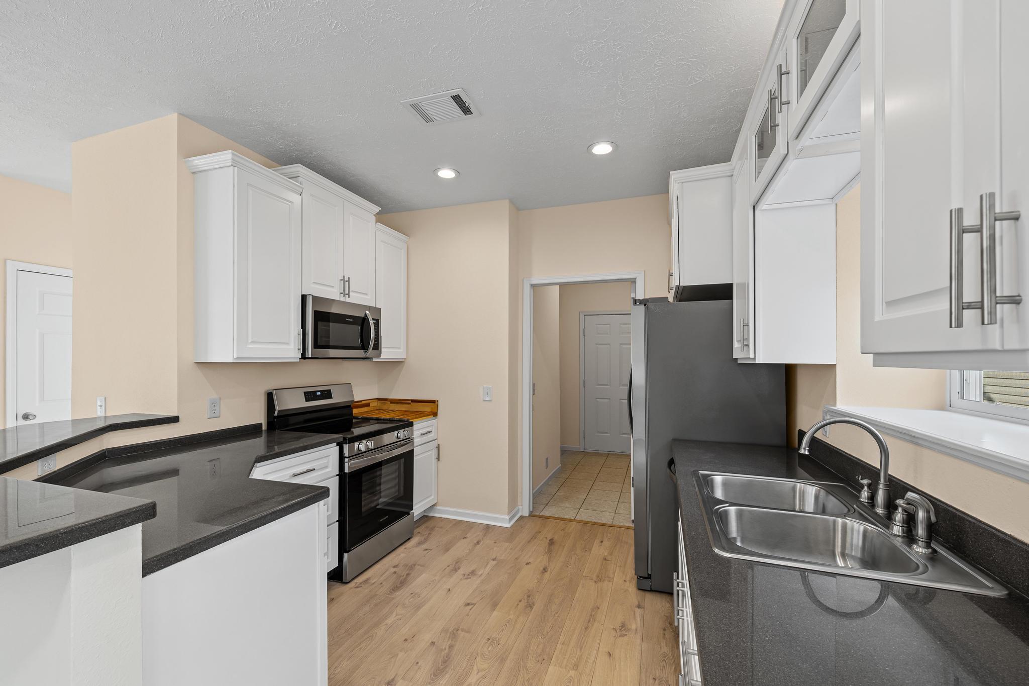3159 Forrest Avenue Crestview, FL 32539 - Photo 17 of 41 a kitchen with stainless steel appliances a sink stove and refrigerator