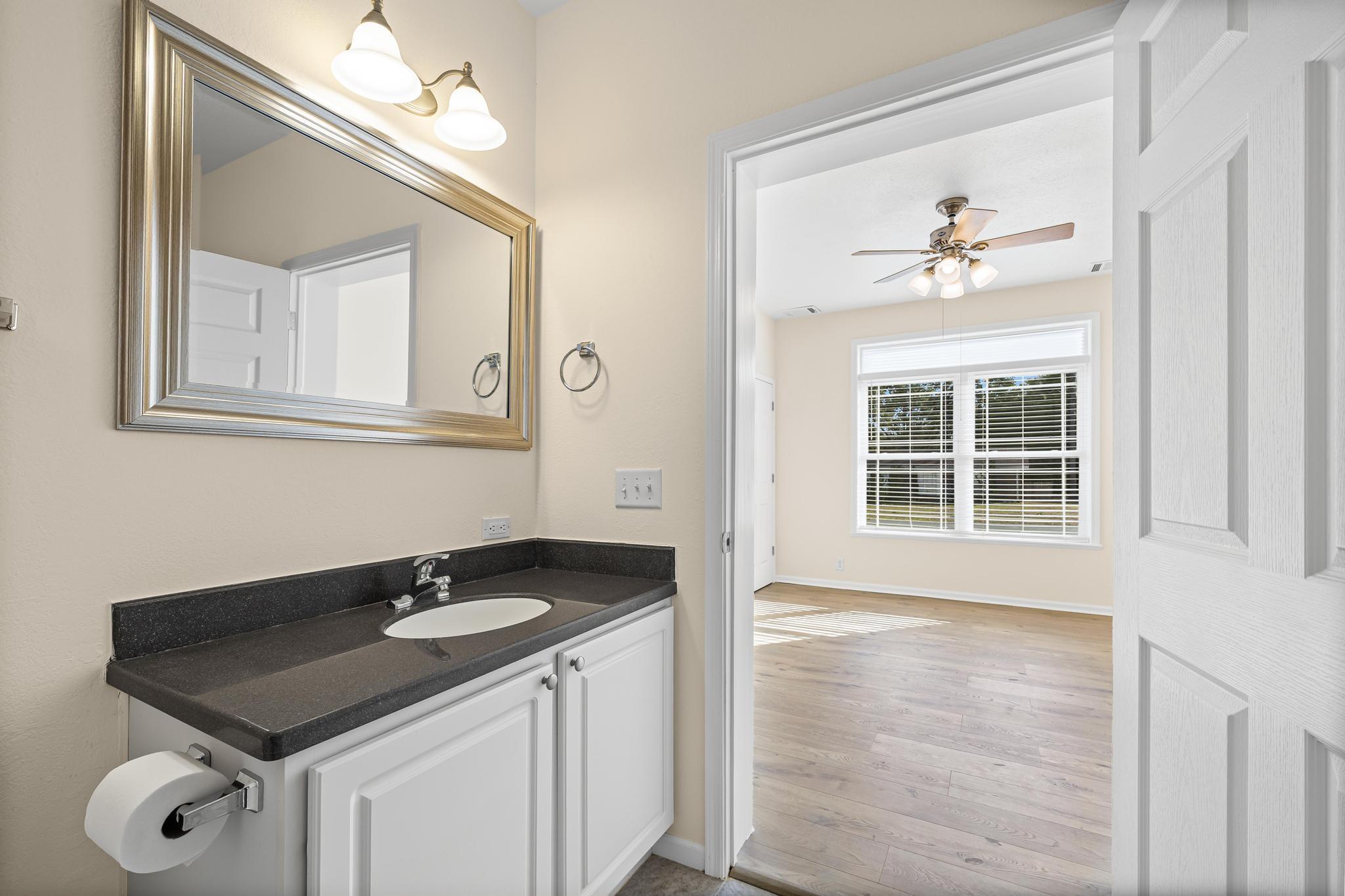 3159 Forrest Avenue Crestview, FL 32539 - Photo 24 of 41 a bathroom with a sink vanity and a mirror