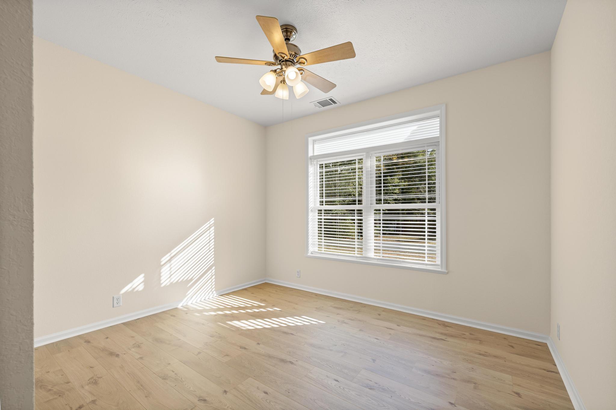 3159 Forrest Avenue Crestview, FL 32539 - Photo 28 of 41 an empty room with a window and a ceiling fan