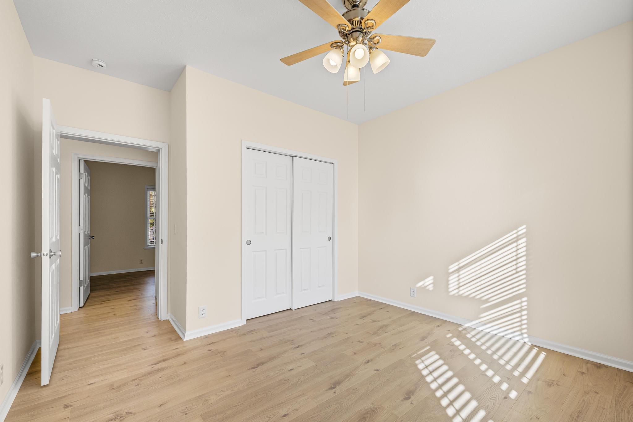 3159 Forrest Avenue Crestview, FL 32539 - Photo 29 of 41 a view of a bedroom with a chandelier fan and wooden floor