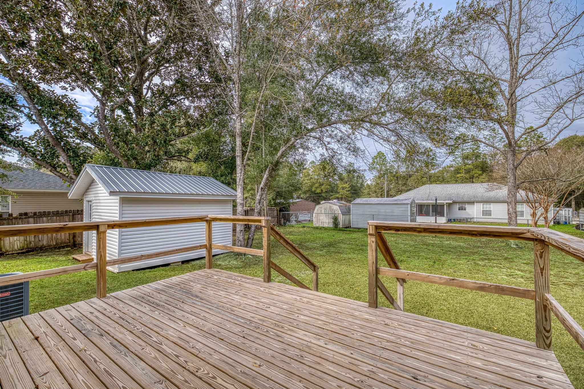 3159 Forrest Avenue Crestview, FL 32539 - Photo 34 of 41 a view of a roof deck with wooden floor and fence
