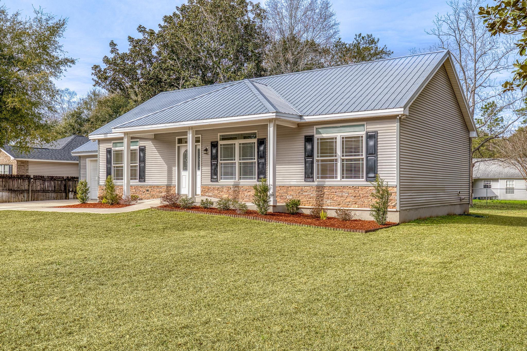 3159 Forrest Avenue Crestview, FL 32539 - Photo 5 of 41 a view of a house with a yard and sitting area