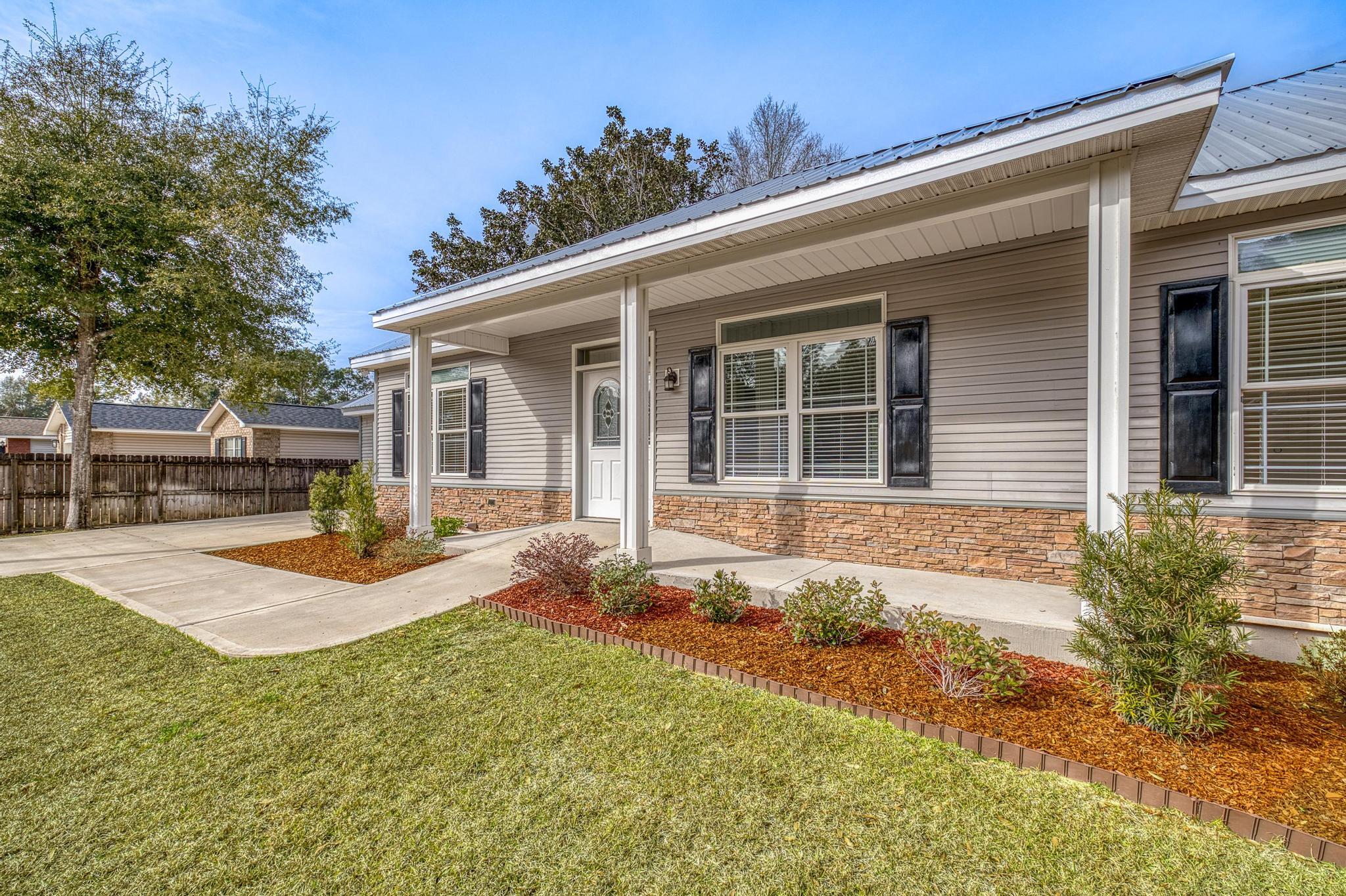 3159 Forrest Avenue Crestview, FL 32539 - Photo 6 of 41 a front view of a house with yard and porch