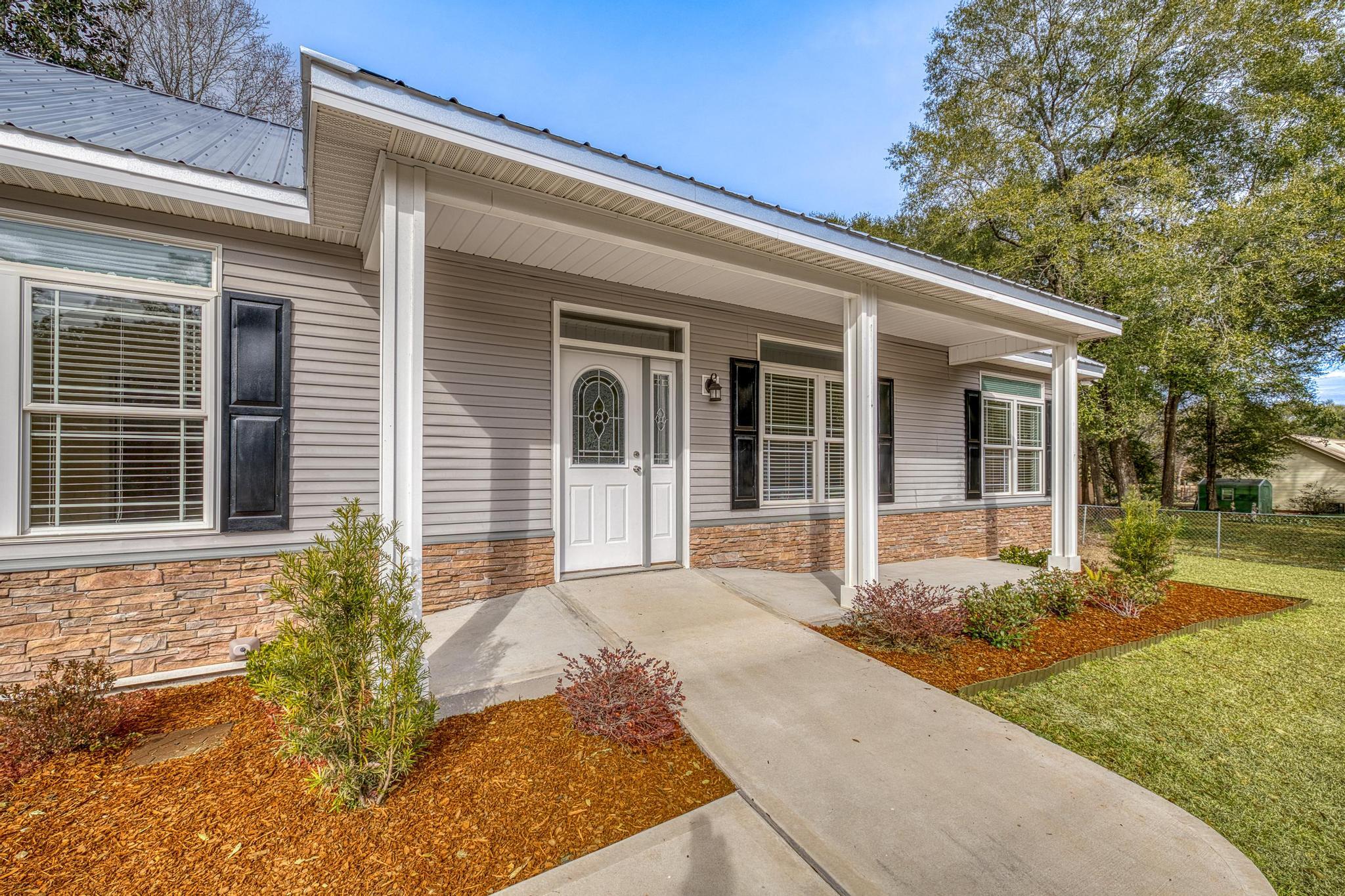 3159 Forrest Avenue Crestview, FL 32539 - Photo 7 of 41 a front view of a house with garden