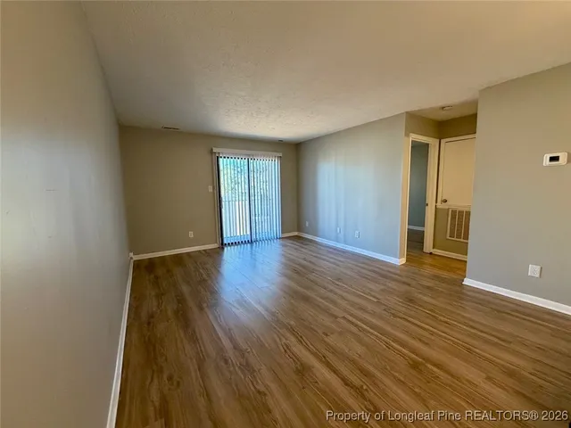 a living room with furniture a flat screen tv and a large window
