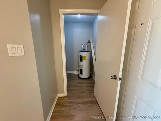 a kitchen with a refrigerator and wooden floor