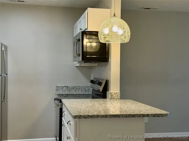 a kitchen with a refrigerator and window