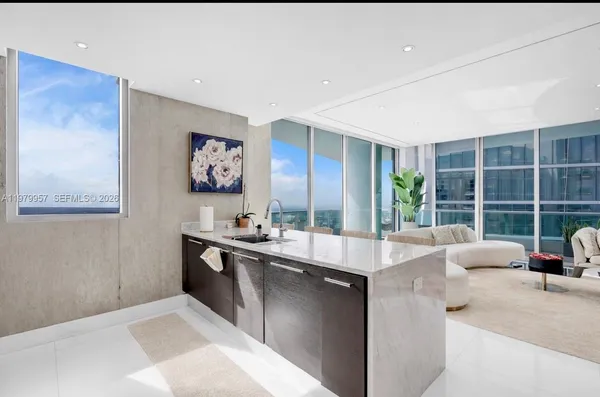 a view of kitchen with stainless steel appliances granite countertop a sink and a counter top space