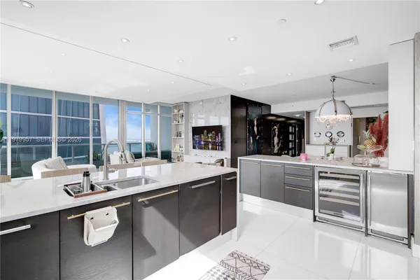 a kitchen with stainless steel appliances kitchen island granite countertop a sink and cabinets