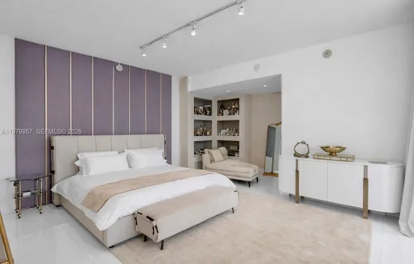 a spacious bedroom with a bed and a window