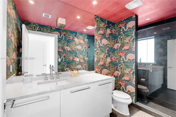 a bathroom with a sink toilet and shower