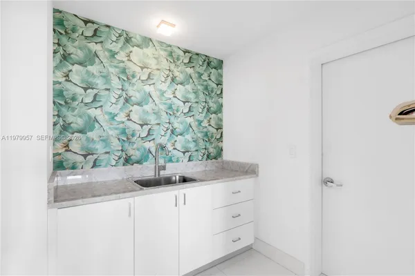 a bathroom with a granite countertop sink a mirror and shower curtain