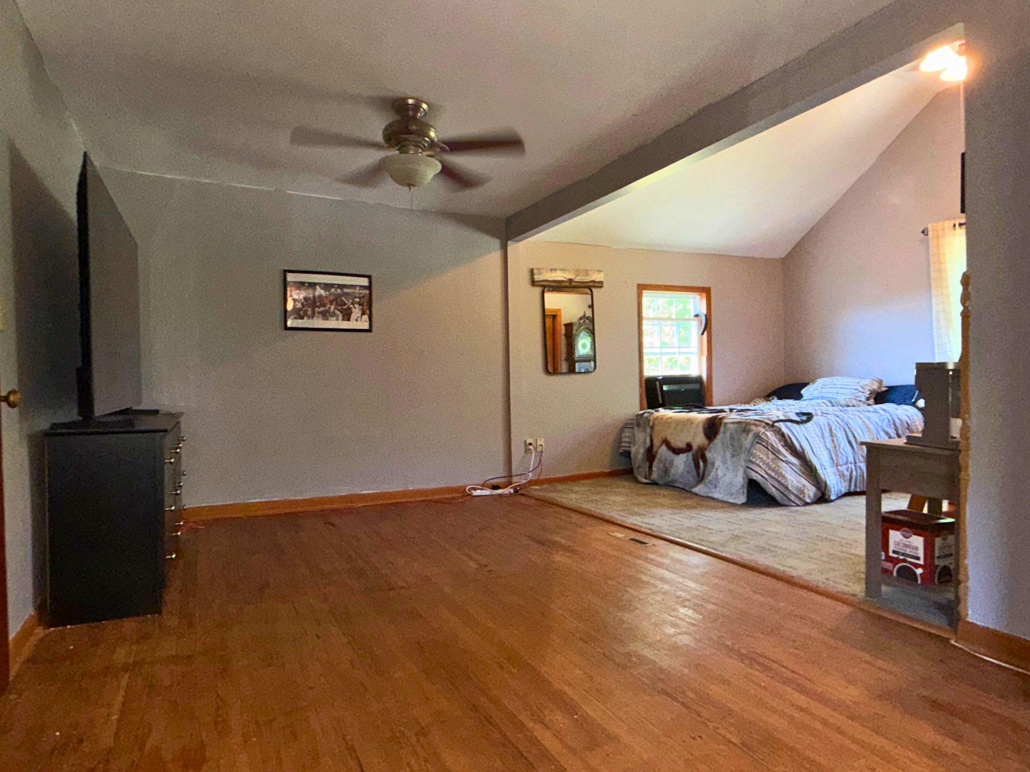 4818 Piney Neck Road Rock Hall, MD 21661 - Photo 15 of 24 a bed room with a bed and a television