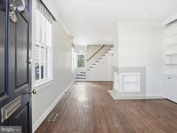 a view of an entryway with wooden floor