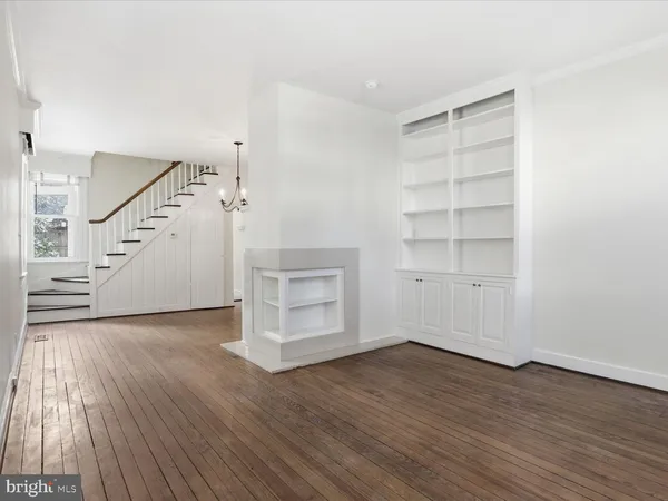a view of a room with wooden floor and staircase