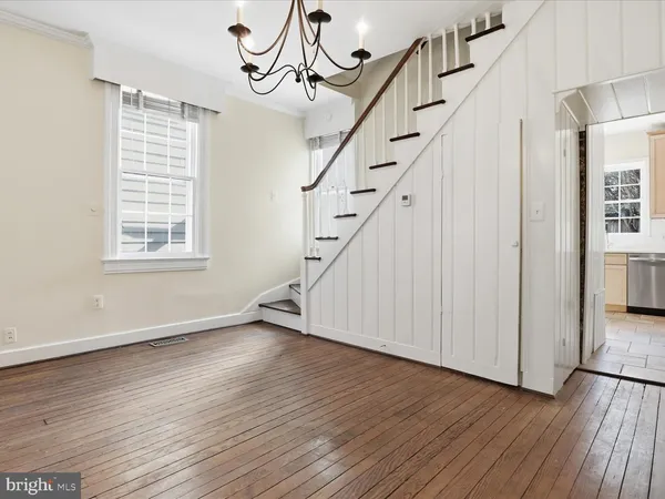 a view of an entryway with wooden floor and stairs