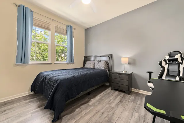 a bedroom with a bed and wooden floor