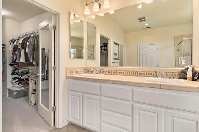a bathroom with a sink a vanity and a mirror