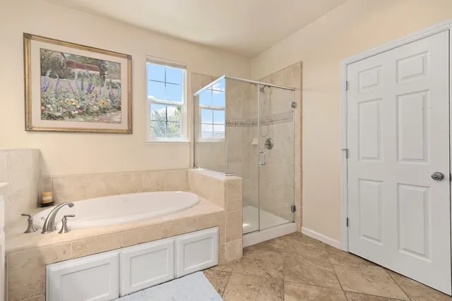a bathroom with a tub and shower