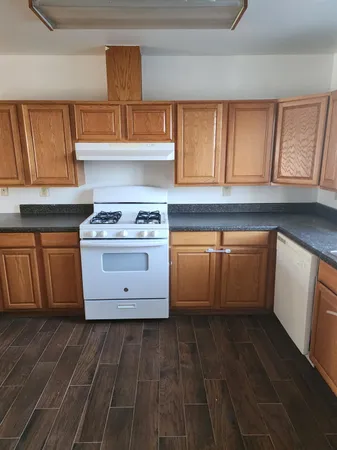a kitchen with stainless steel appliances granite countertop a stove and a sink