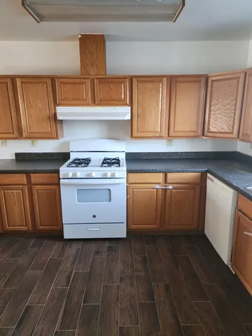 a kitchen with stainless steel appliances granite countertop a stove and a sink