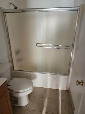 a bathroom with a toilet and a shower