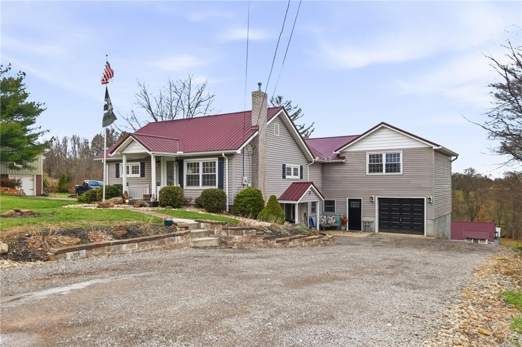 27 Bock Lane Baden, PA 15005 - Photo 2 of 50 a front view of a house with a yard and garage