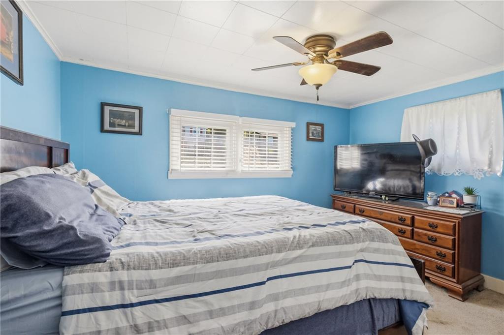 27 Bock Lane Baden, PA 15005 - Photo 26 of 50 a bedroom with a bed and a chandelier
