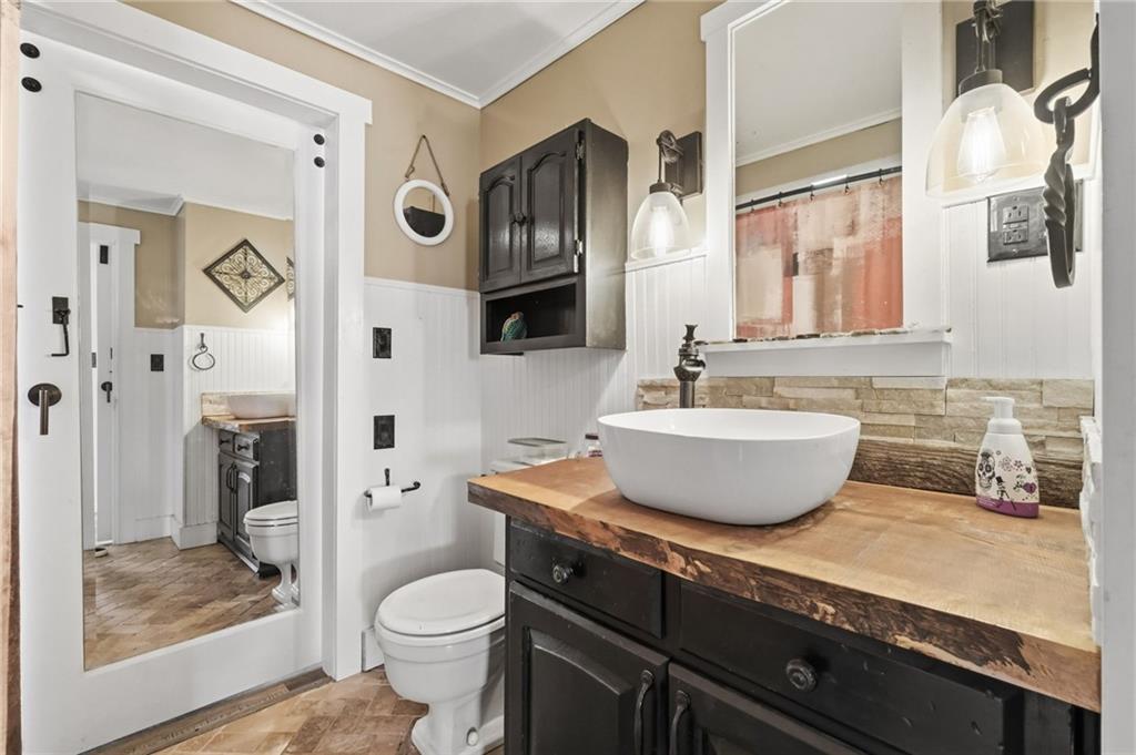 27 Bock Lane Baden, PA 15005 - Photo 29 of 50 a bathroom with a granite countertop toilet sink and mirror